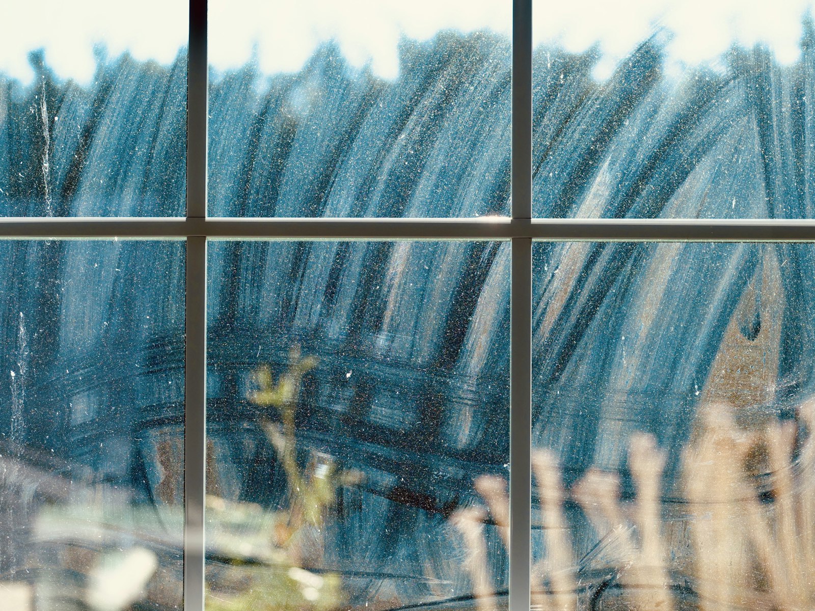 Freshly soaped window pane being cleaned